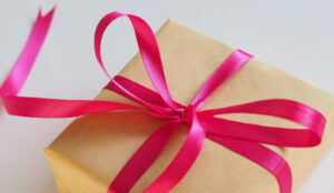 After divorce gift wrapped in brown paper and tied with a pink ribbon.