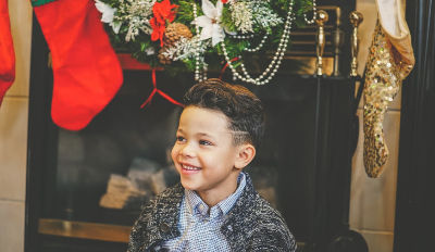 Little boy smiling for his Christmas picture.