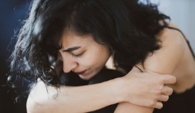 Woman hanging her head with her grief after divorce.