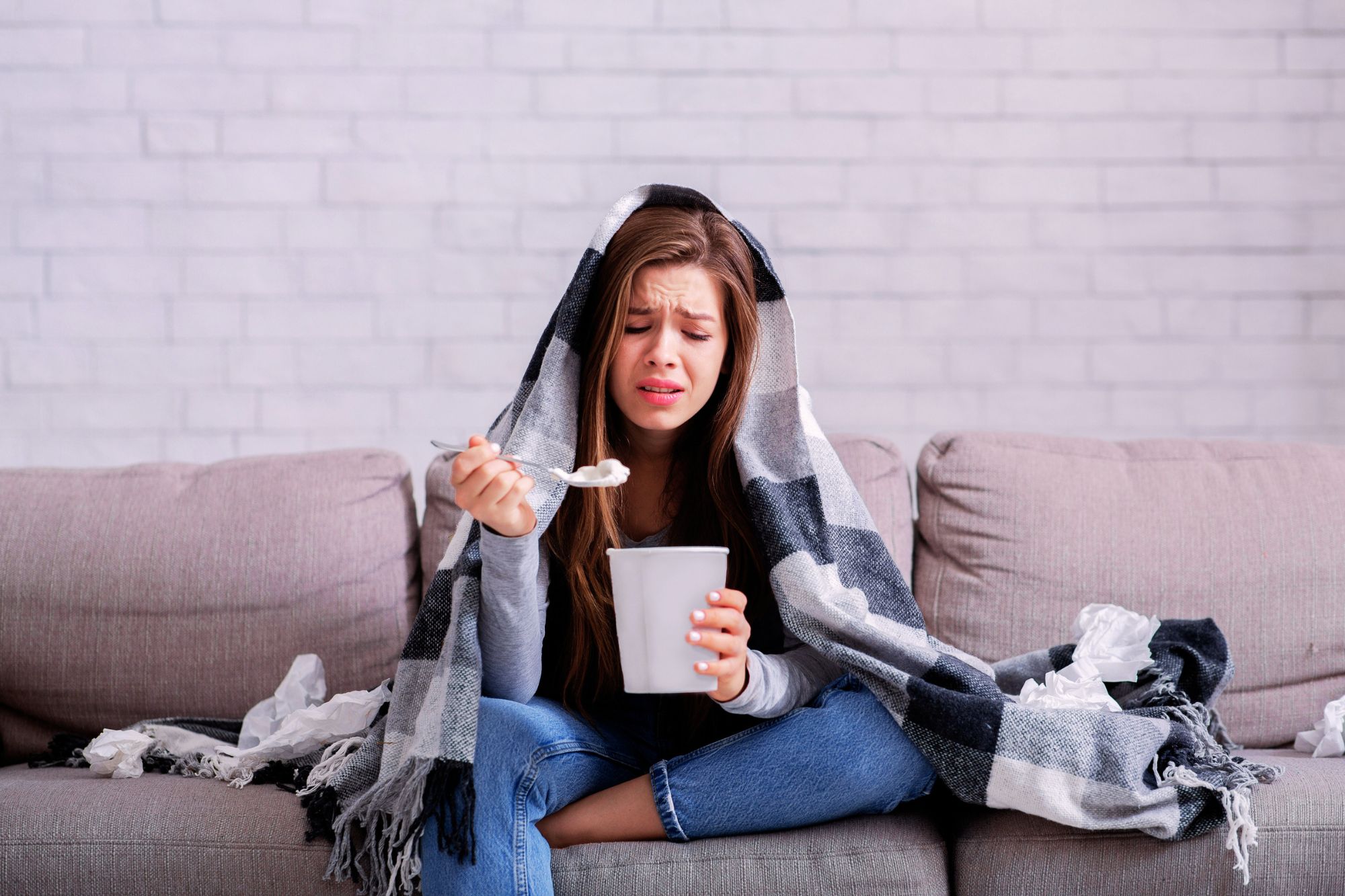 heartbroken woman eating ice cream looking for ways to finally get over your ex.