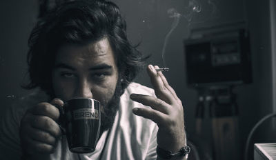 Man drinking coffee, holding a cigarette and being an emotional bully.