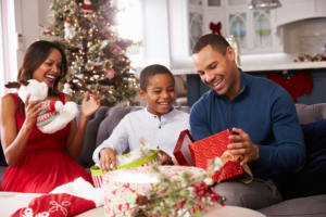 Father, mother, & son opening Christmas presents on couch, 3 ways to make it through the holidays when your marriage is over.
