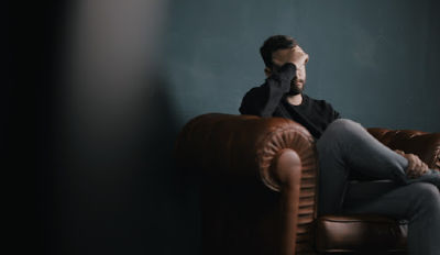 Man holding his head and wondering how to deal with divorce.