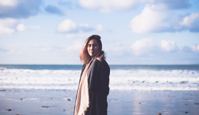 Woman walking on beach wondering how to get over a divorce.