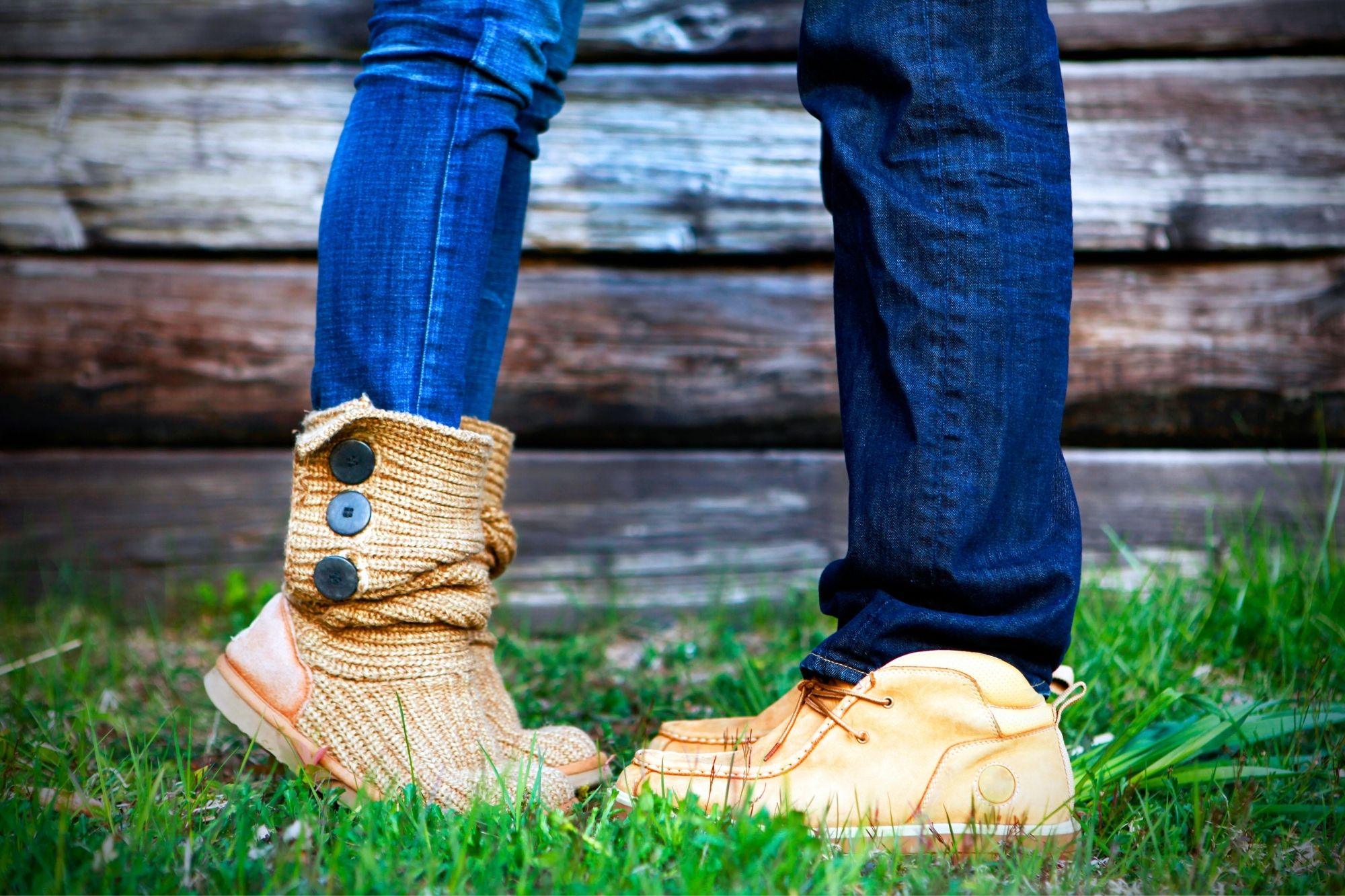 Close up of the legs and shoes of a man and woman facing each other closely as they discuss the 2 common mistakes that will give you an unhappy marriage. She is wearing short boots and is standing on her toes, he is wearing tan loafers.