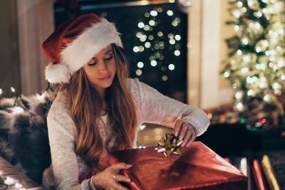 Woman contentedly wrapping a present for the holidays despite dealing with divorce.