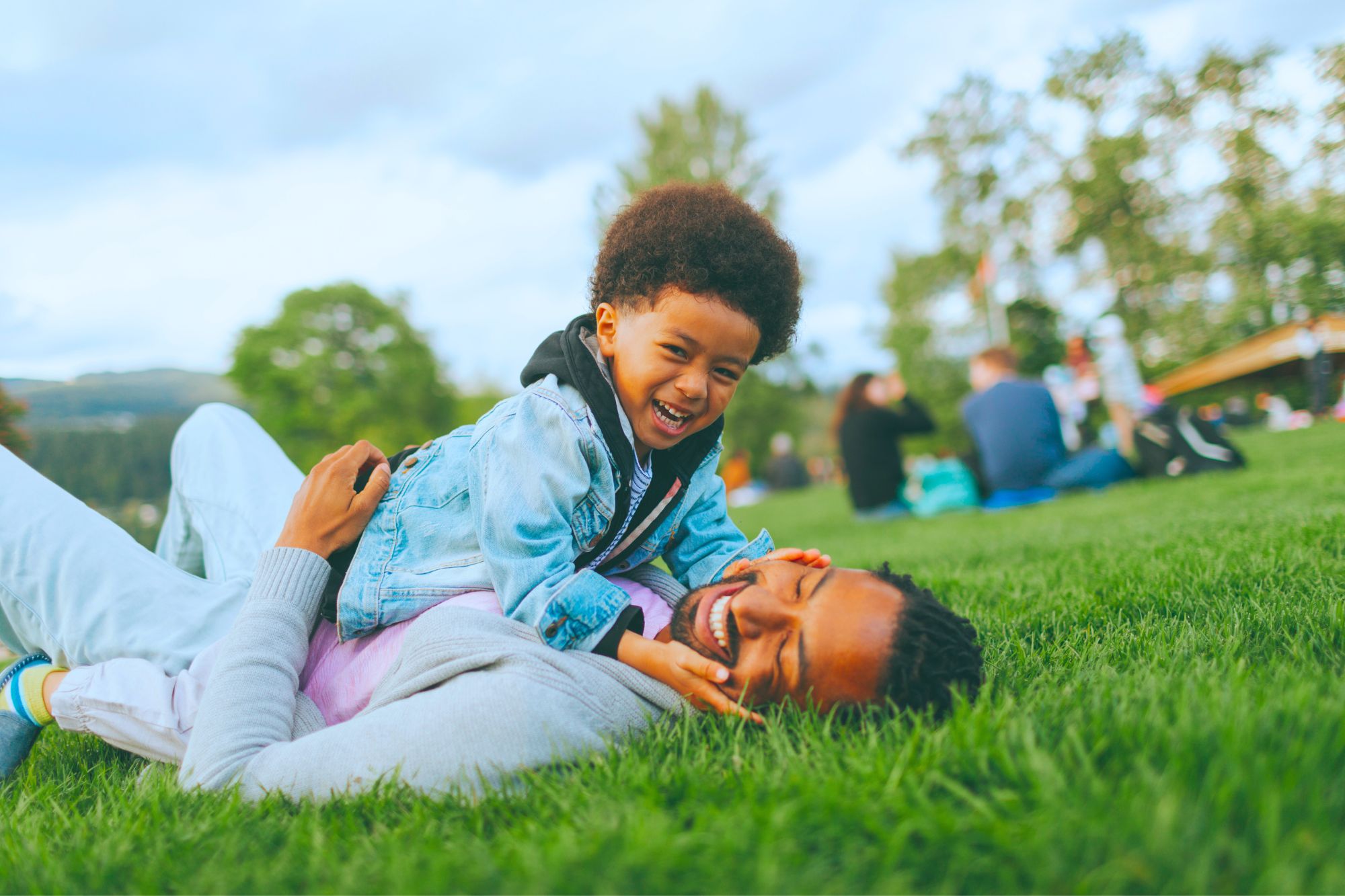 Father and son playing in the grass while applying the 3 tips for raising an incredible child even if your ex sucks.