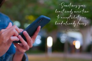 Women alone texting the 15 surviving infidelity quotes to help you heal. 1 quote is displayed: "Sometimes your heart needs more time to accept what your head already knows"
