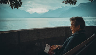 Man looking out at a lake wondering how to get over a divorce and an affair.