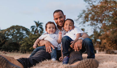 Man sitting with his sons in his lap realizing that life after divorce for dads can be really good.