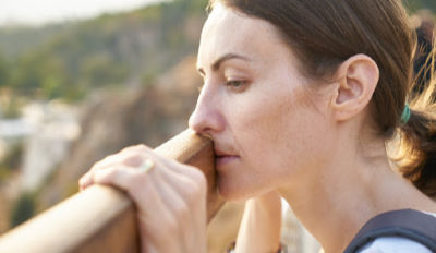 Woman looking over the landscape wondering what to do about her miserable second marriage.