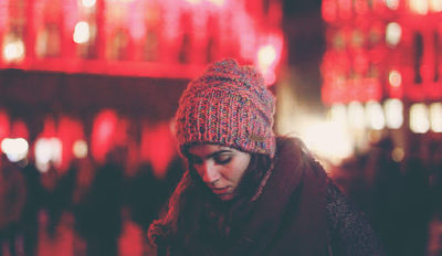 Woman wearing a red hat wondering how to begin dealing with grief after a divorce.