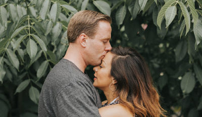 Married couple hugging under a tree after discovering how to fix an unhealthy marriage.