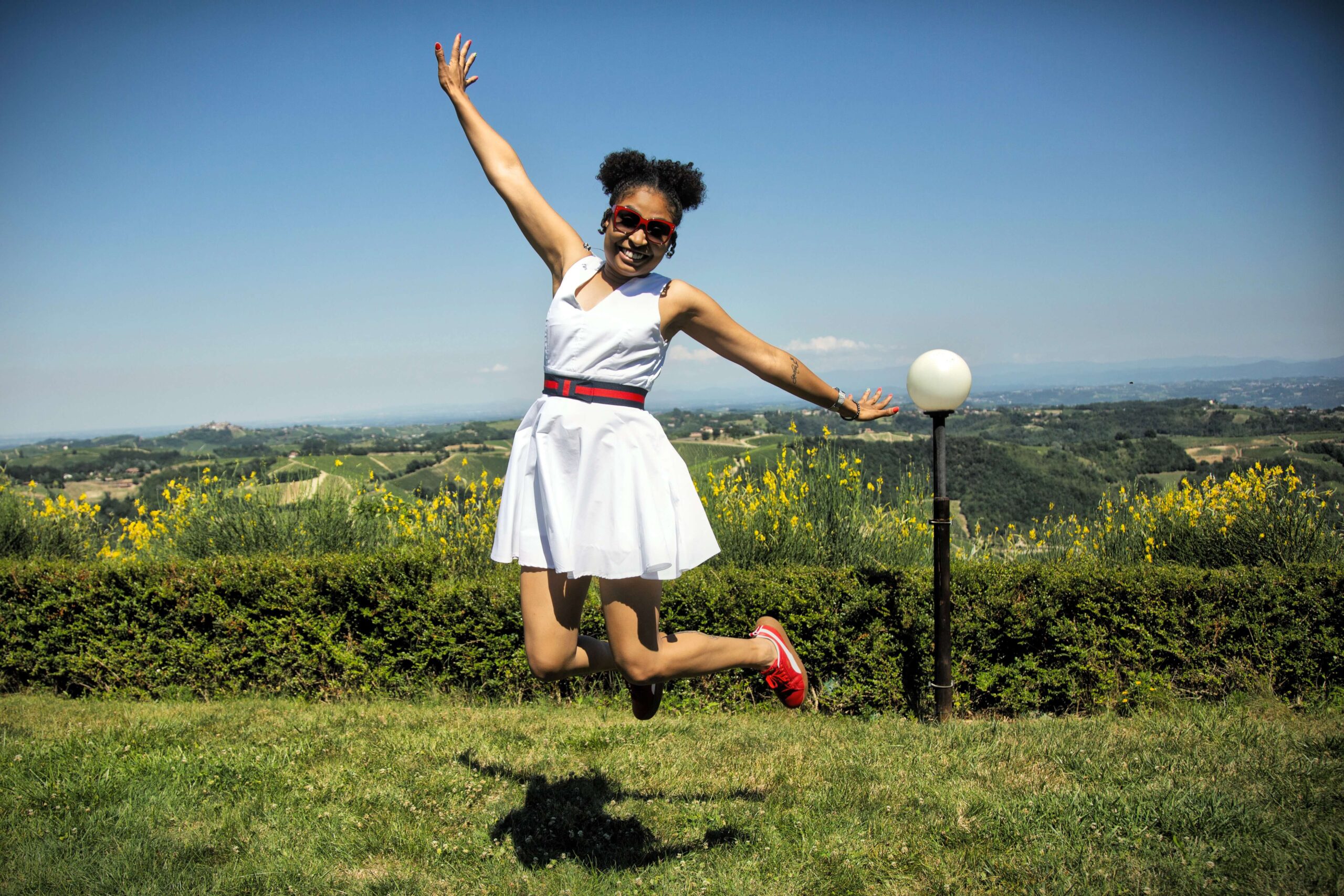 Woman jumping for joy because she is living a happy and healthy life.