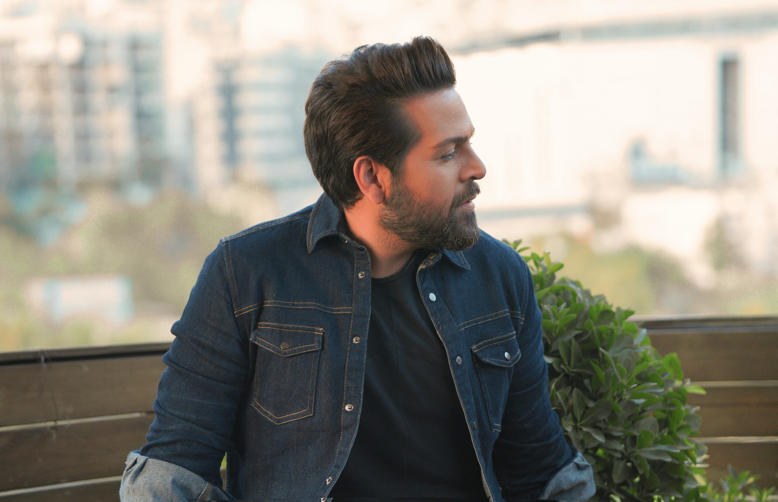 Man sitting on a balcony and contemplating his self-awareness.