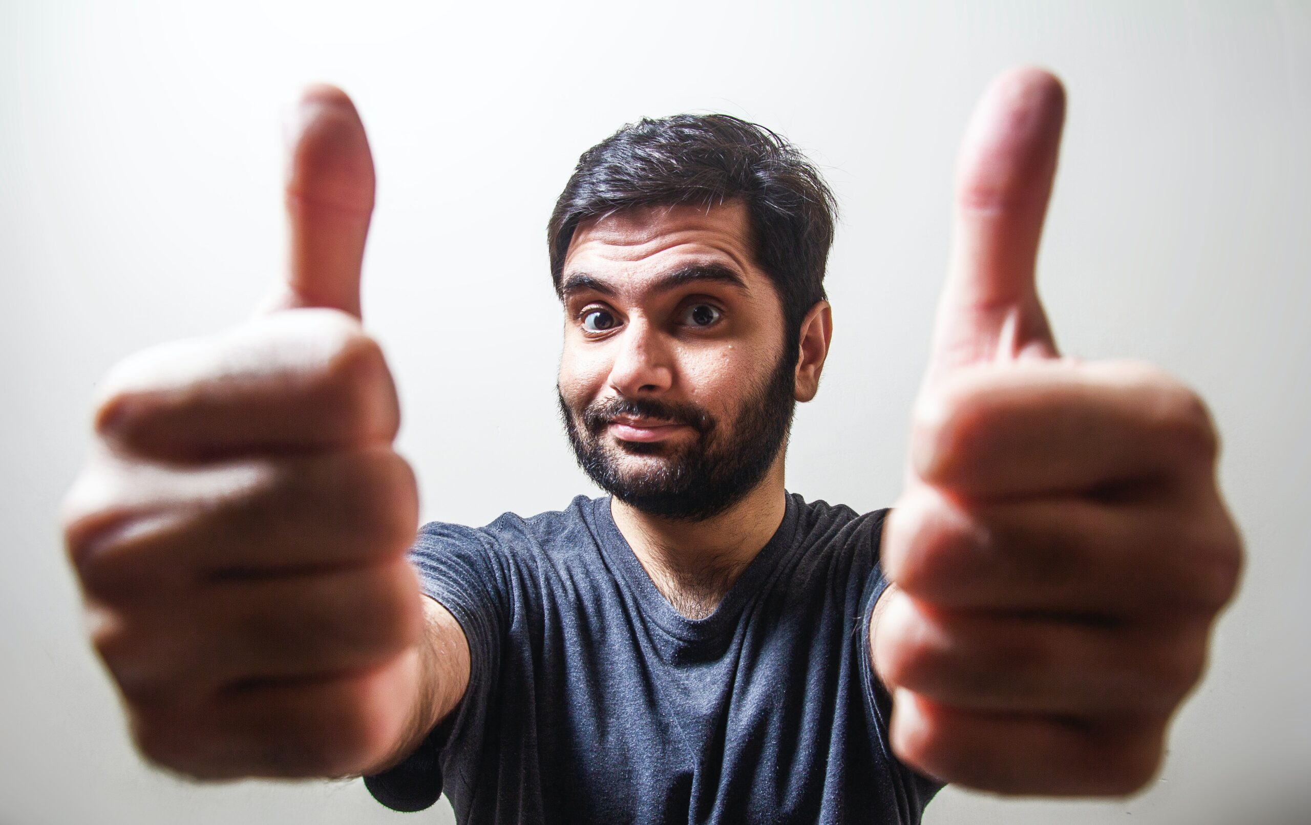 Man giving 2 thumbs up because he can say, "My life got better after divorce."