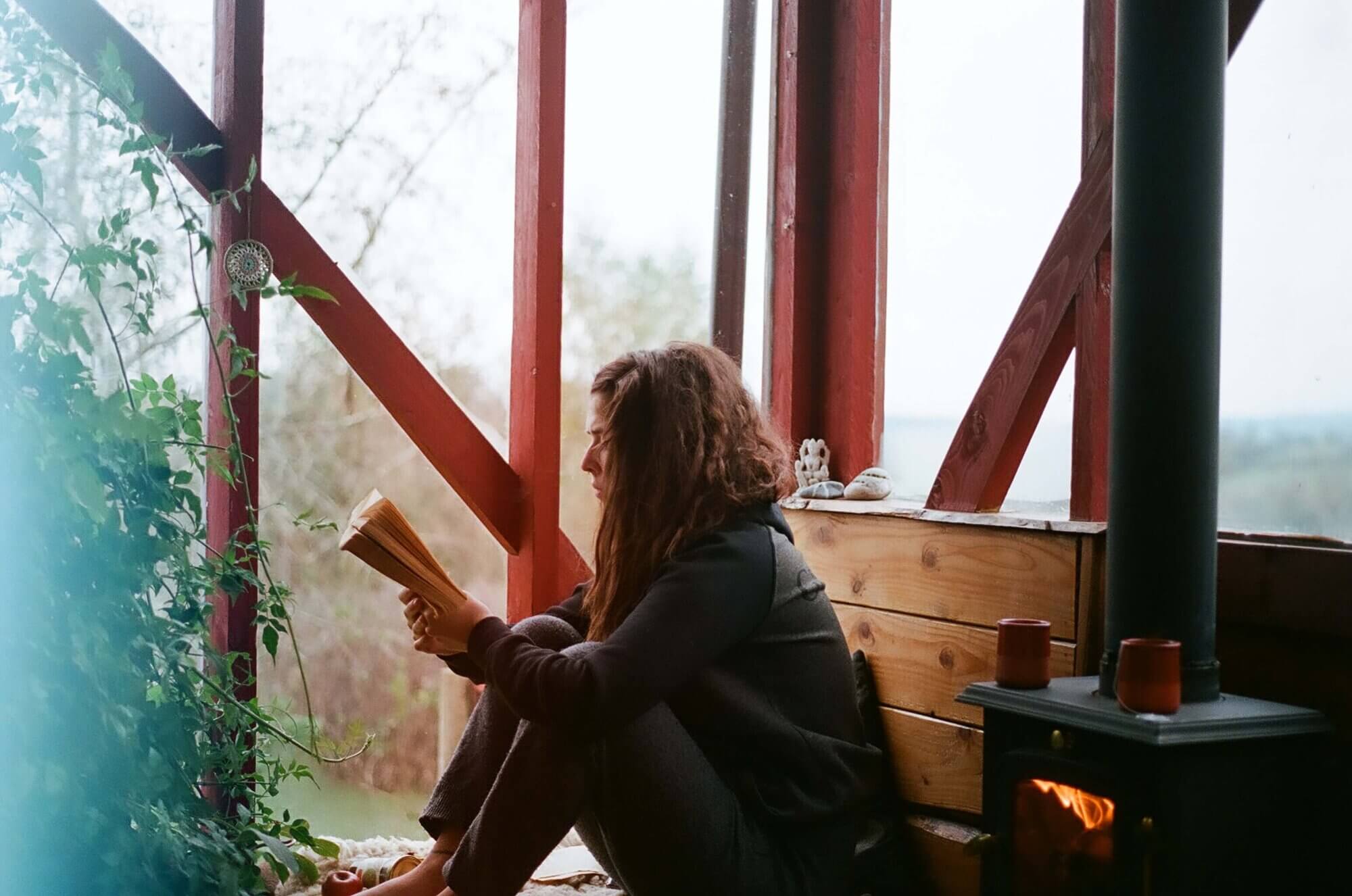 Woman sitting on the floor reading moving on with life after divorce quotes.