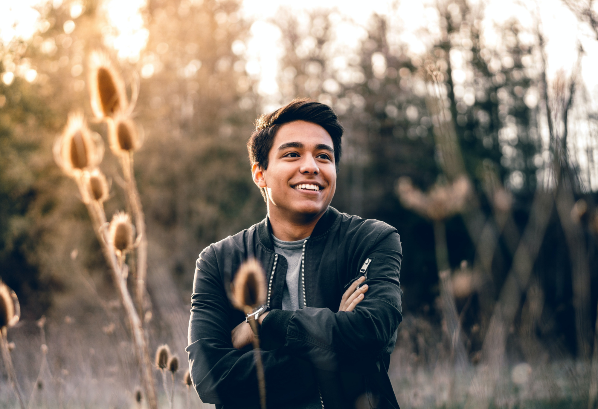 Happy man standing in an autumn meadow.