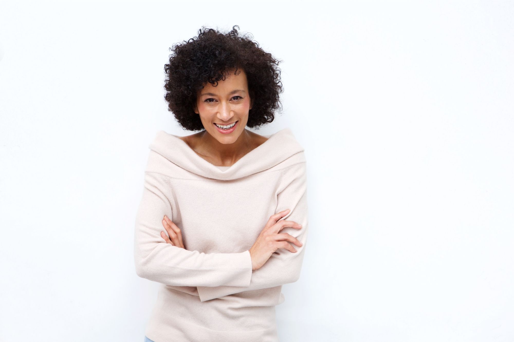 Woman with her arms crossed waiting expectantly for the answer to how to live a happy life post-divorce.