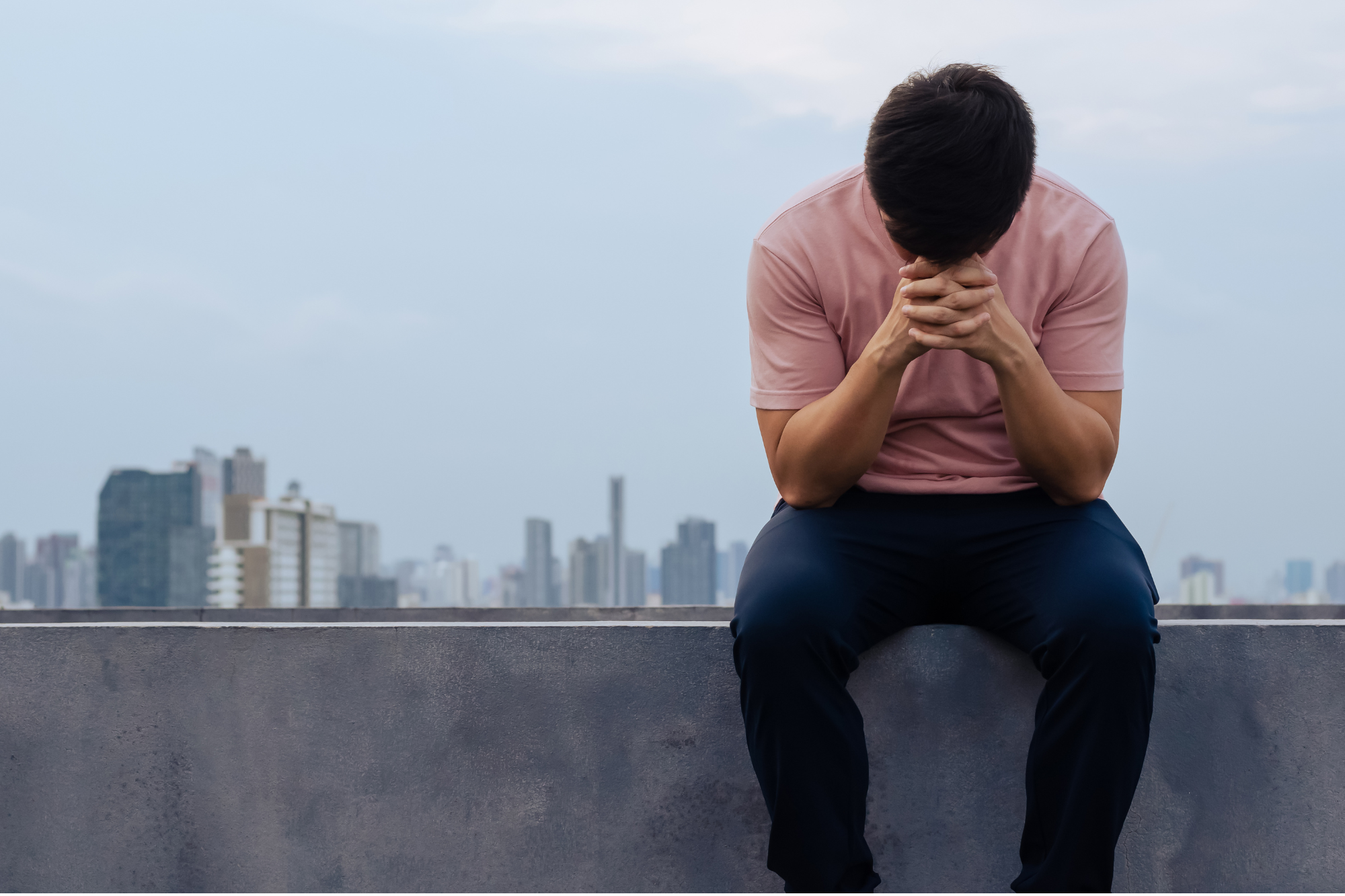 Man sitting with his head in his hands wondering how to fix his miserable marriage.