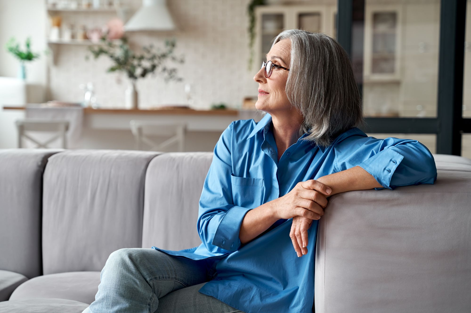 Confident and self-aware woman sitting on the couch.